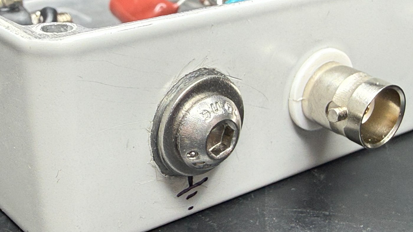 Paint removed in a ring around the main stud, tooth lock washer biting into bare metal